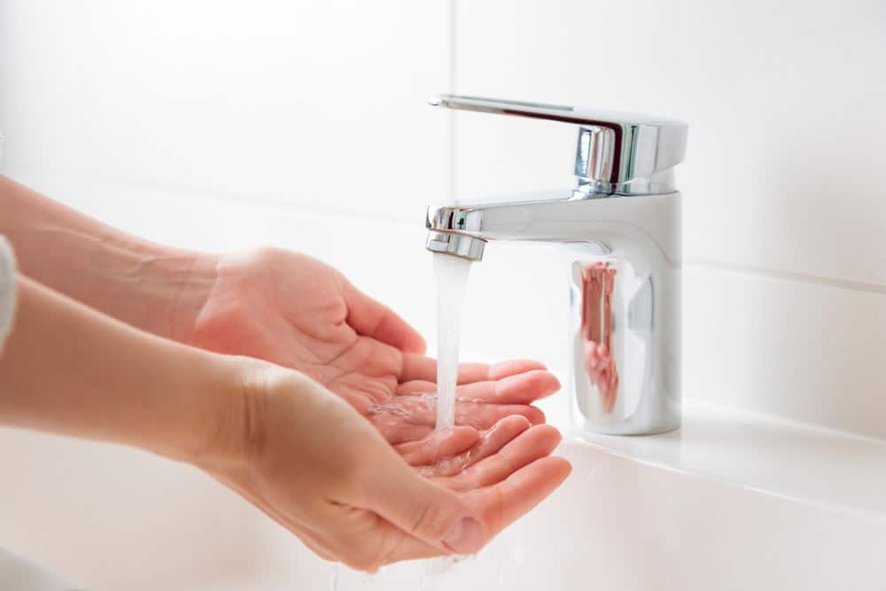 tap water flowing down a hand